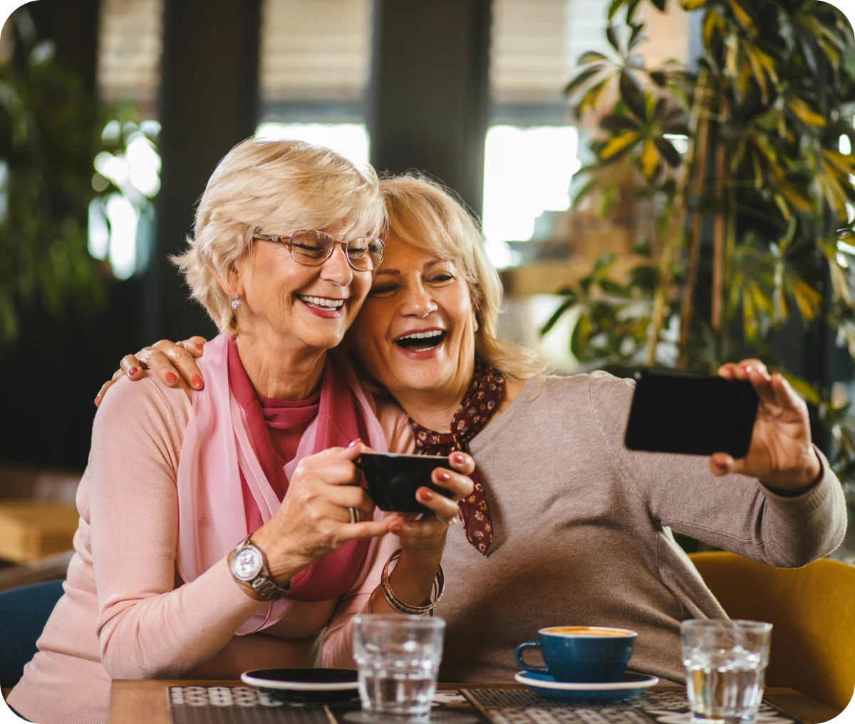 Happy seniors enjoying coffee together