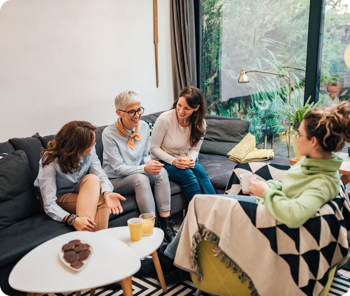Group of women relaxing with drinks.